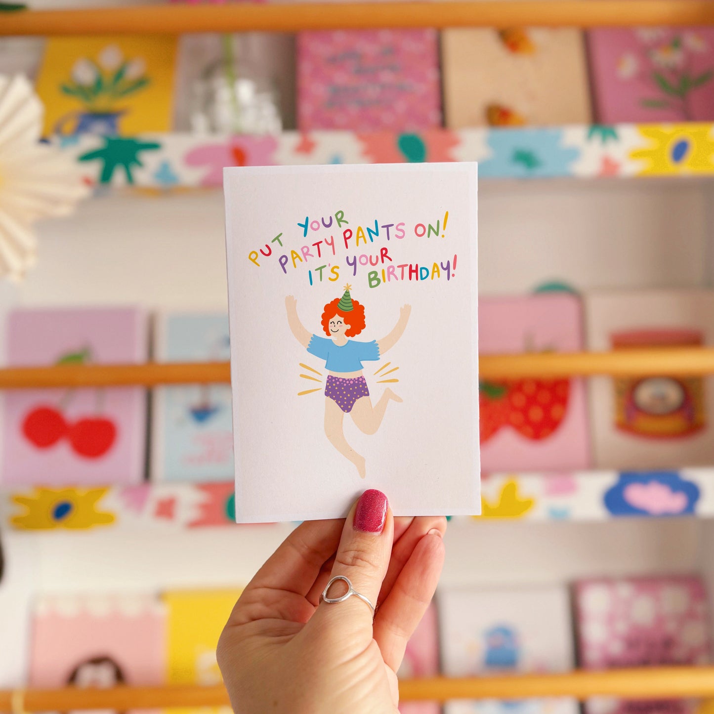 A colourful birthday card with a person jumping for joy wearing their underwear, with text that reads 'put your party pants on! it's your birthday!'