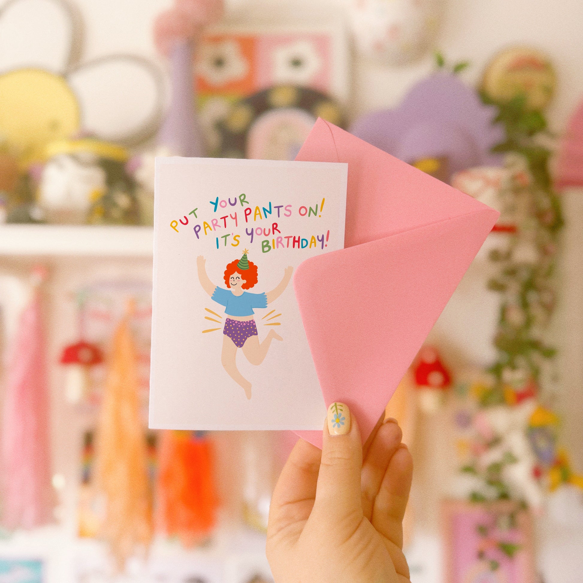 A colourful birthday card with a person jumping for joy wearing their underwear, with text that reads 'put your party pants on! it's your birthday!'