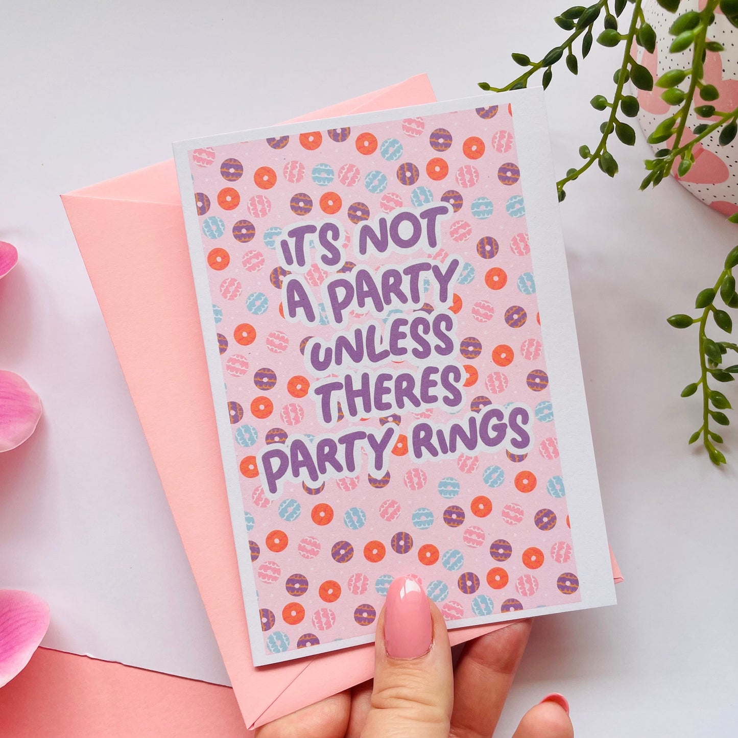 A birthday card, with a party ring pattern, and the text says 'it's not a party unless there's party rings'