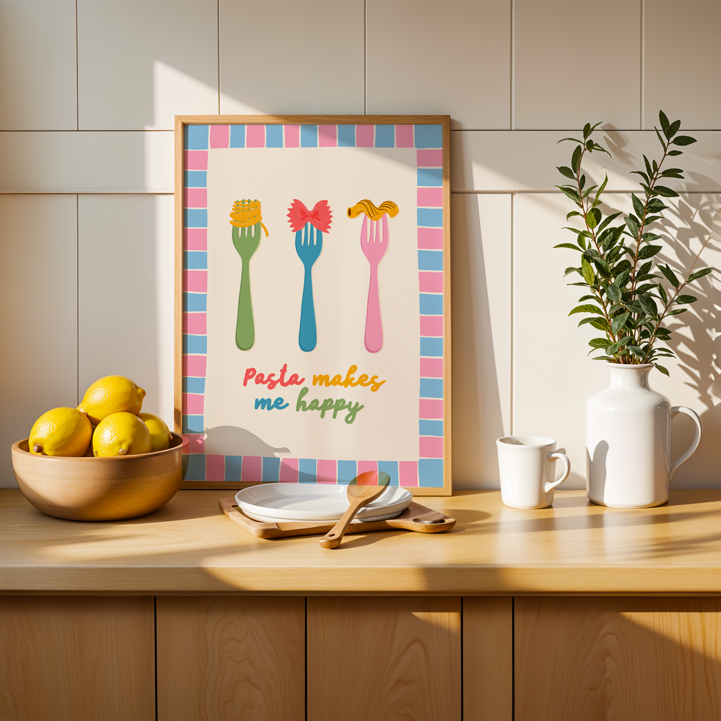 A colourful kitchen print with illustrations of pasta on forks, and a pasta lover quote. Framed by a hand drawn pink and blue border.