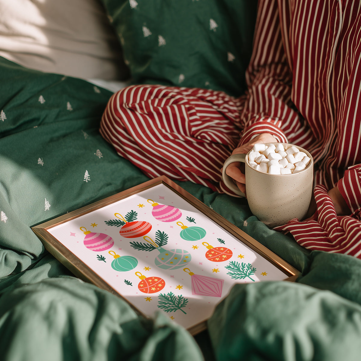 An illustrated Christmas print with 9 brightly coloured baubles, with sprigs of pine decorating the page.