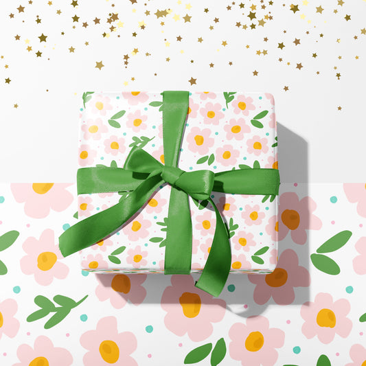 A gift wrapped present, wrapped up in cute pastel floral print gift wrap from The Happy Badger.