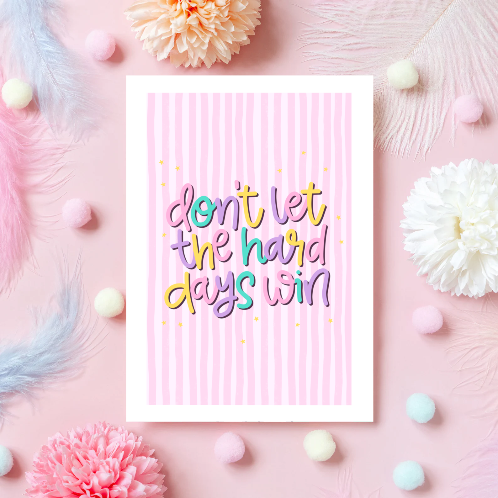 a greeting card, with a pink striped background, and colourful text reading 'Don't let the hard days win'