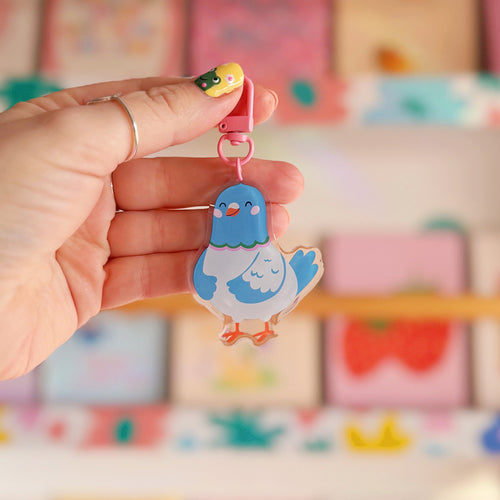 A cute blue pigeon keyring, with a pink clasp.