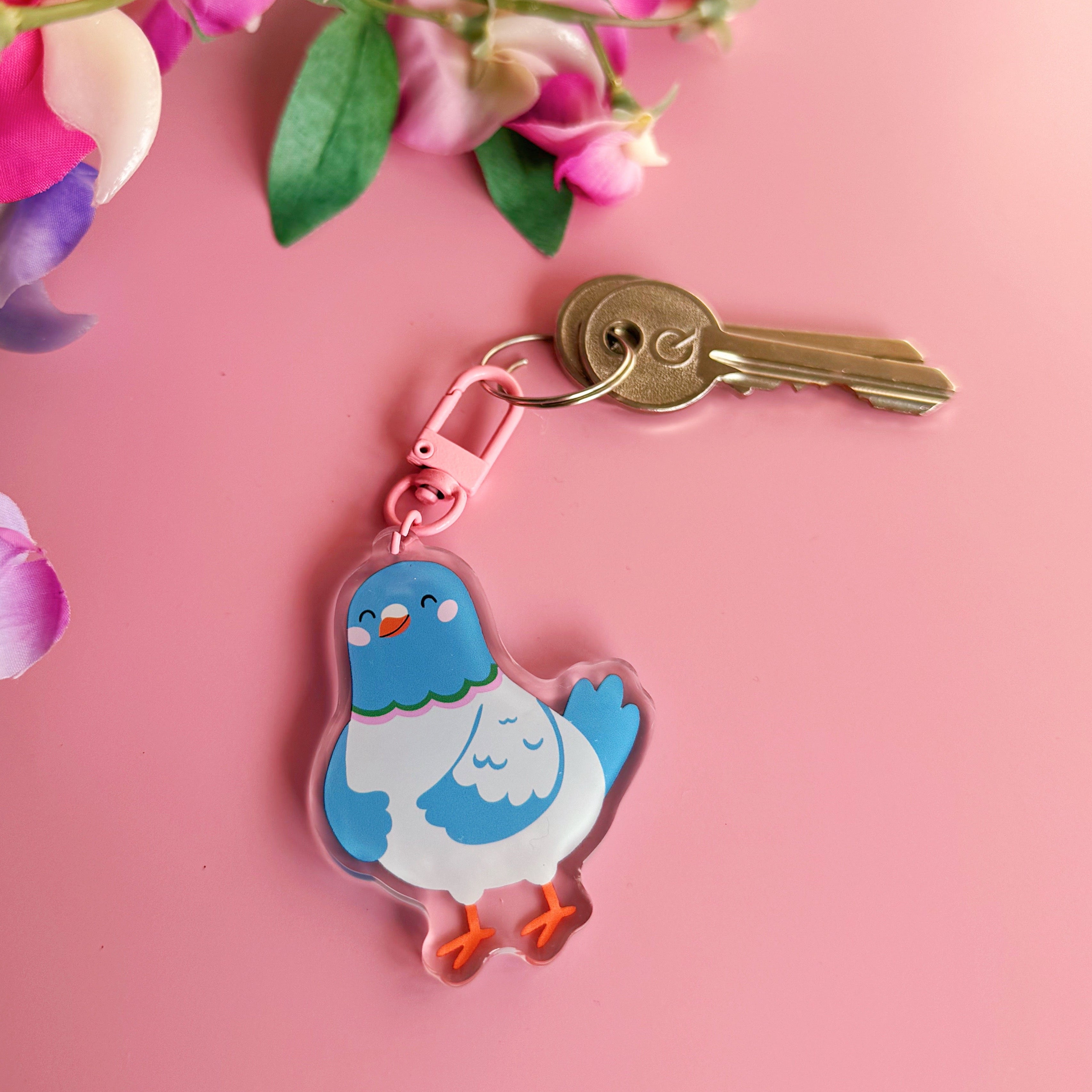 A cute blue pigeon keyring, with a pink clasp.