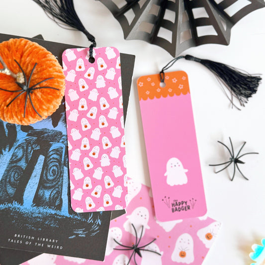 A pink bookmark with little cute ghosts all over it, and a coordinating black tassel.