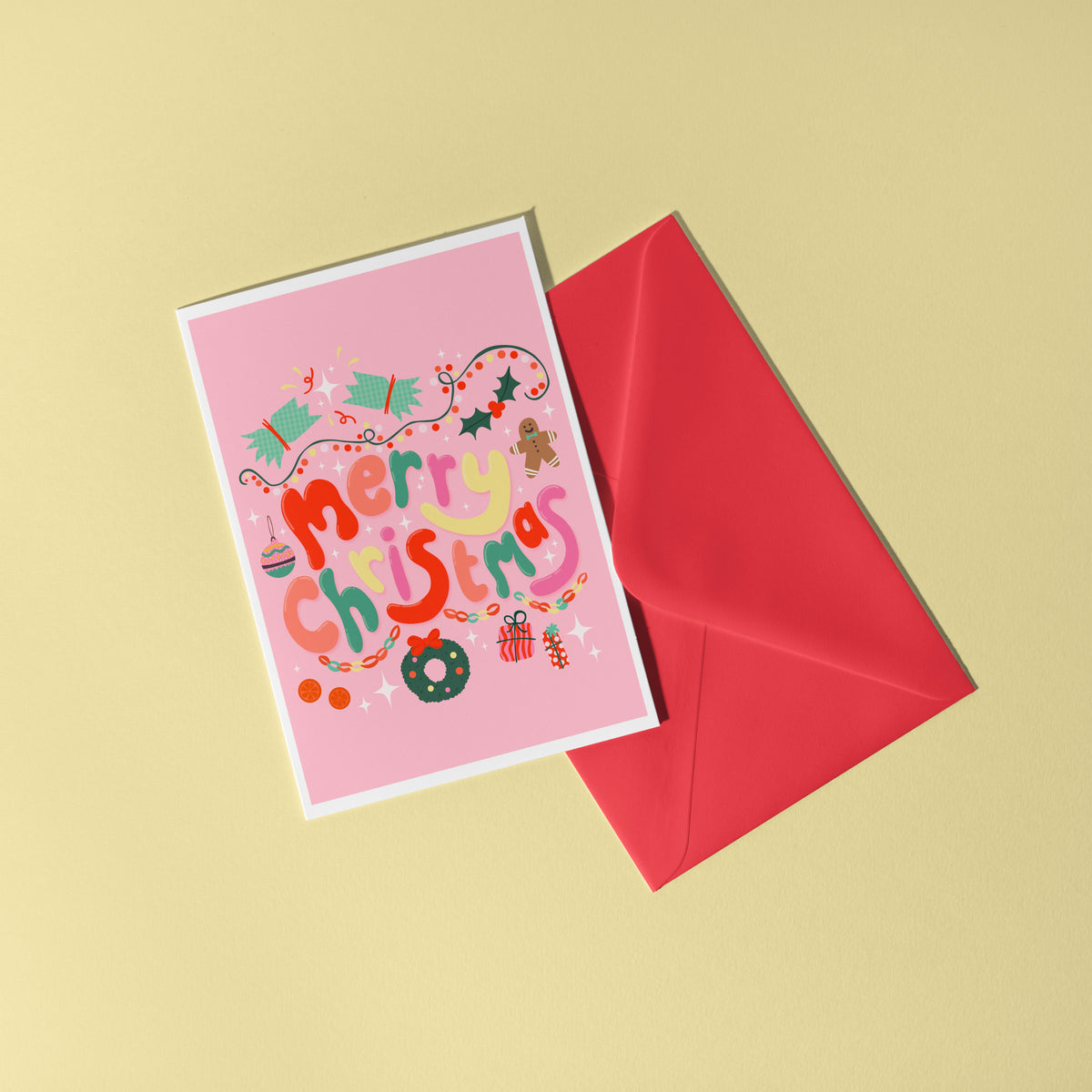A bright pink Christmas greeting card with colourful retro-style lettering and festive illustrations.