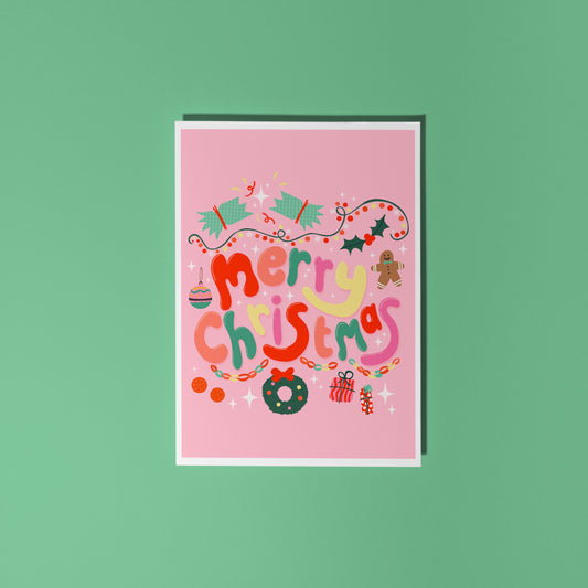 A bright pink Christmas greeting card with colourful retro-style lettering and festive illustrations.