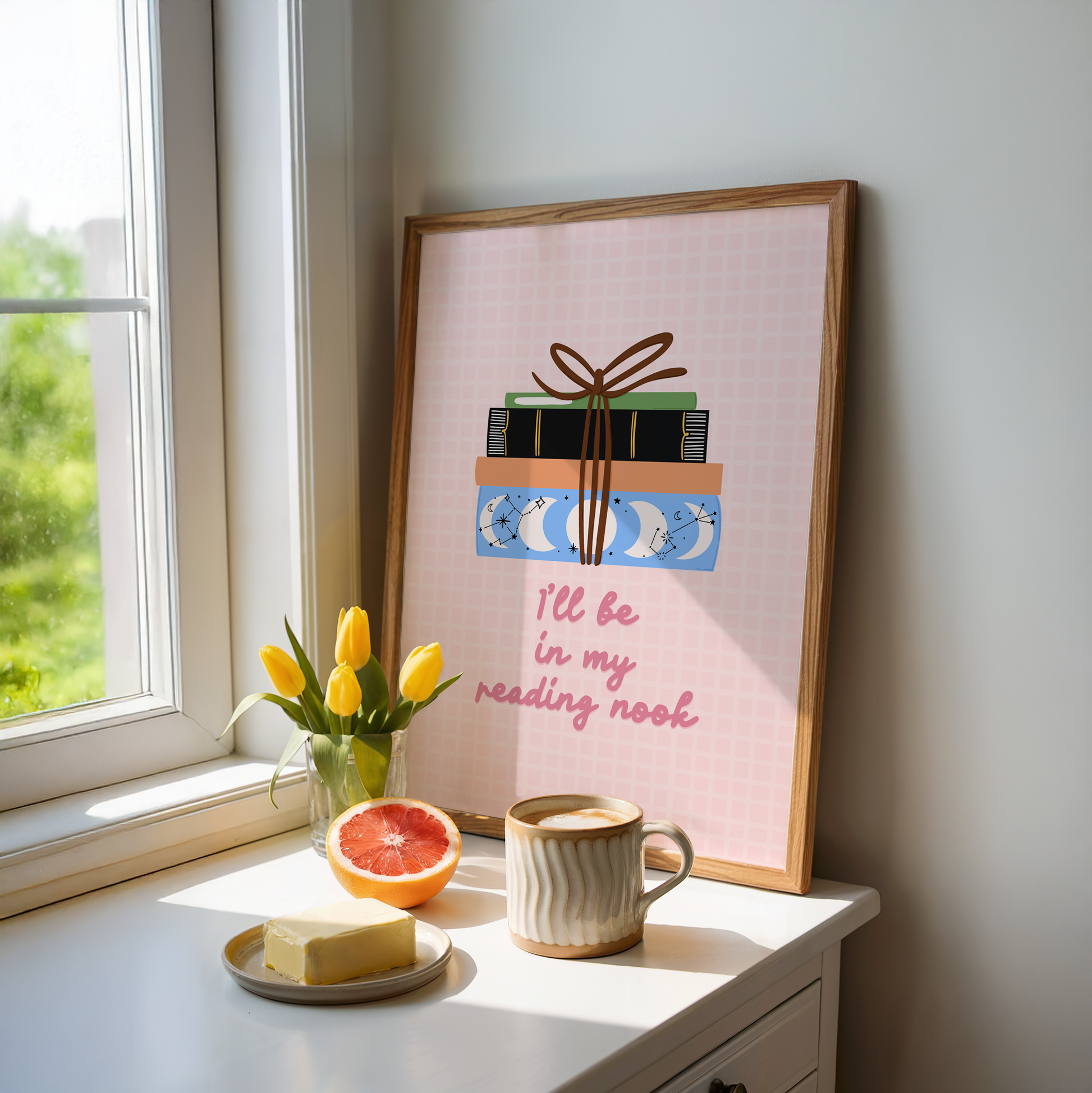A cute pink print, featuring an illustration of a pack of books, and the quote 'I'll be in my reading nook' underneath.
