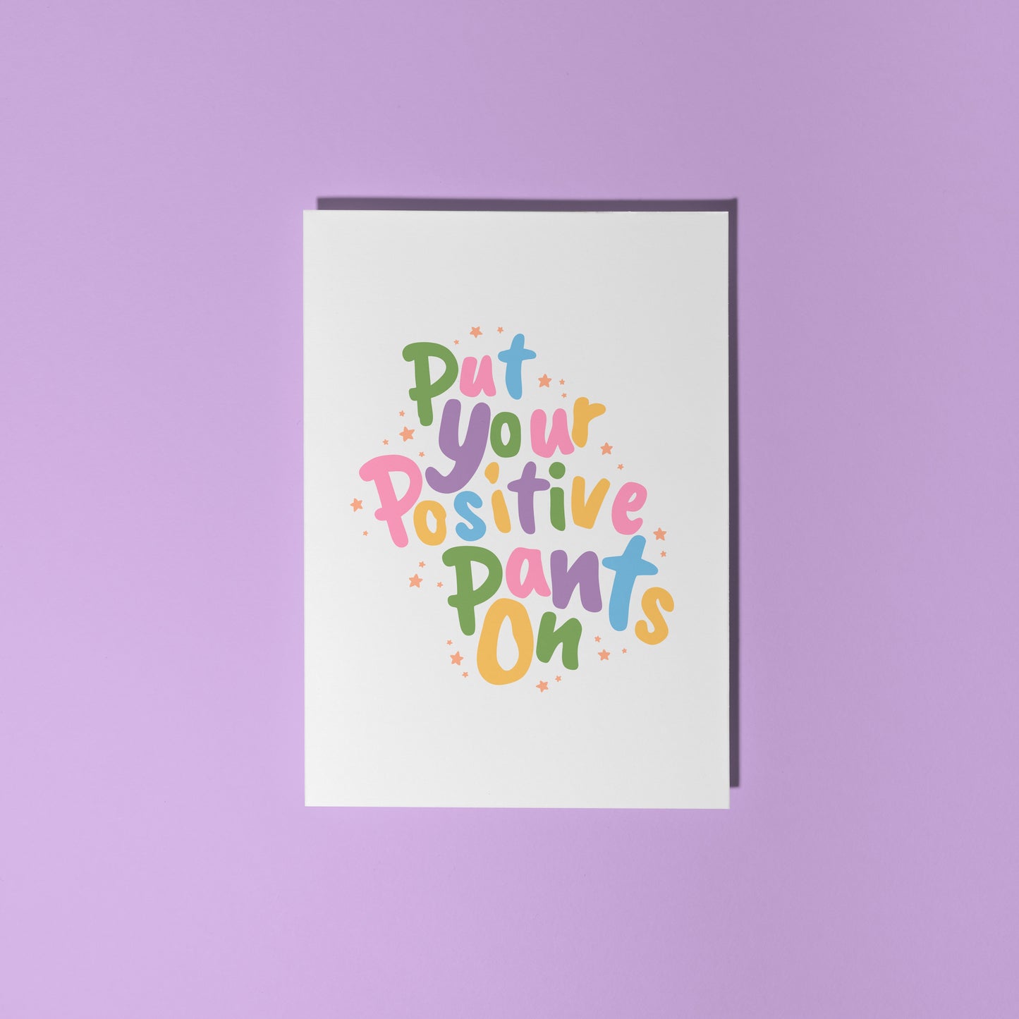 A card with a colourful quote on that reads 'put your positive pants on'.