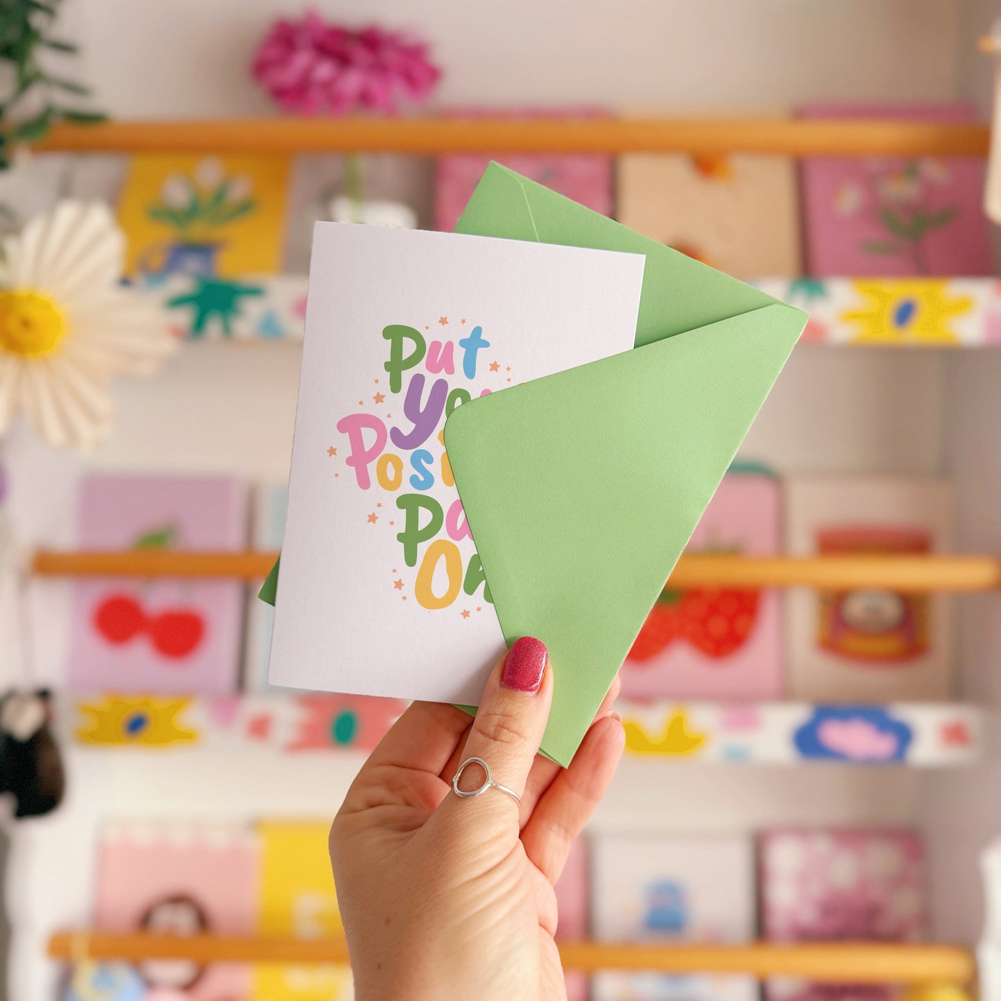 A card with a colourful quote on that reads 'put your positive pants on'.