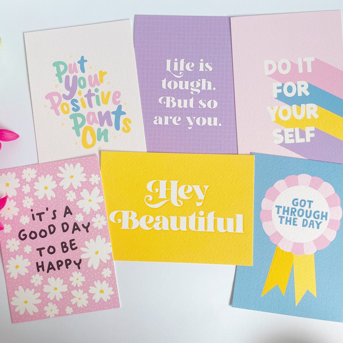 A range of bright and colourful postcards featuring motivational and positivity messages.