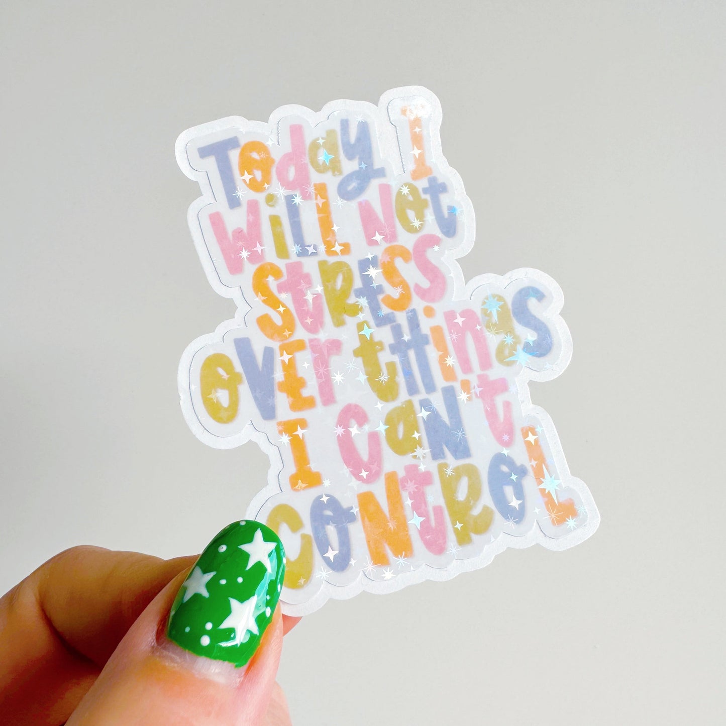 A holographic sticker, with the quote today I will not stress over things I can't control on it. The sticker has an easy peel lip.