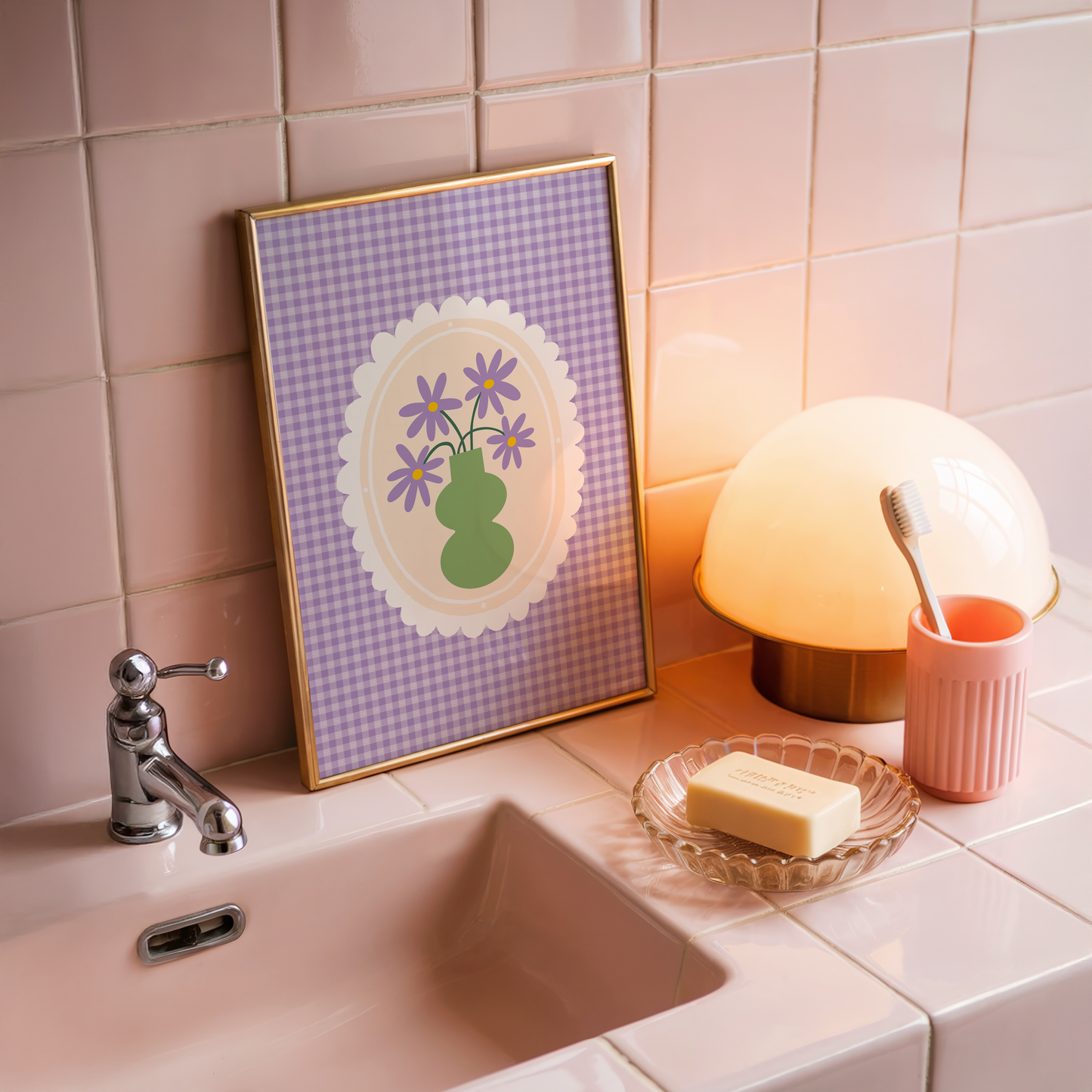 A purple gingham print, with a scalloped frame illustration in the centre. Inside the frame is an illustration of a green vase with purple daisies.