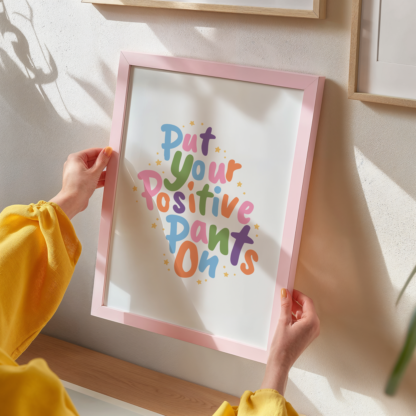 A colourful quote print that says 'put your positive pants on'.