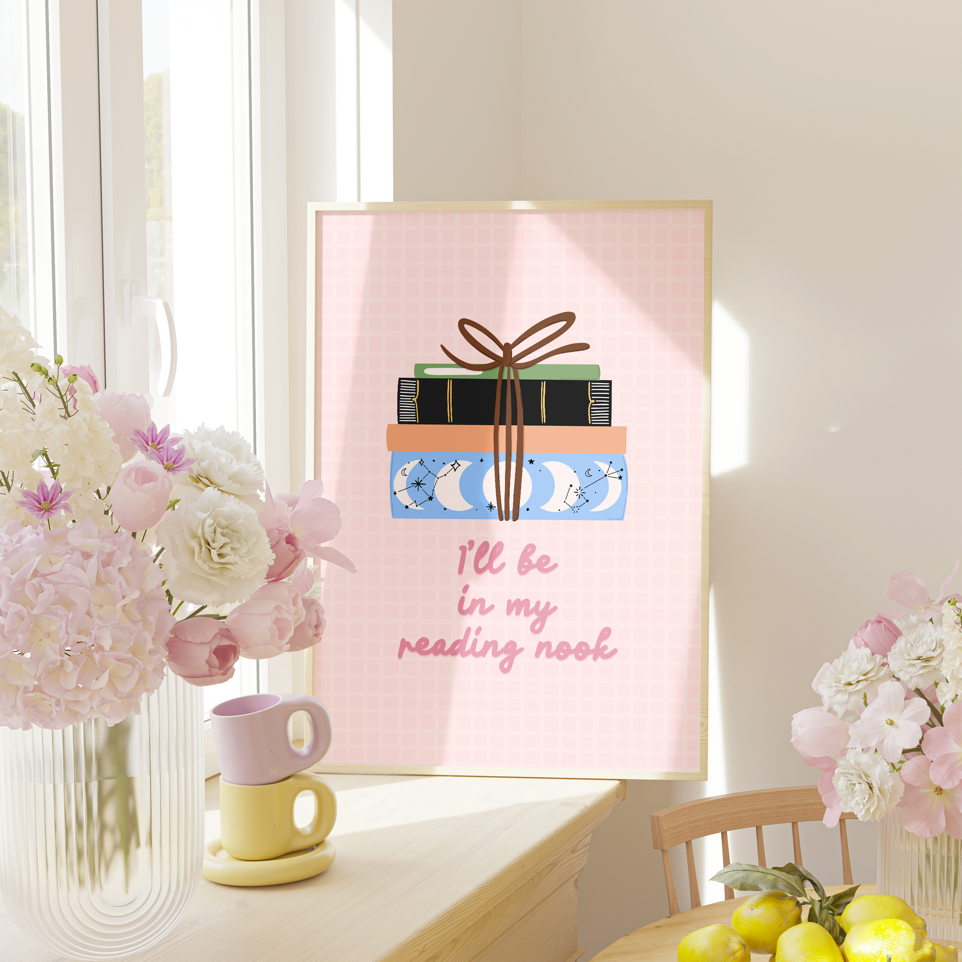 A cute pink print, featuring an illustration of a pack of books, and the quote 'I'll be in my reading nook' underneath.