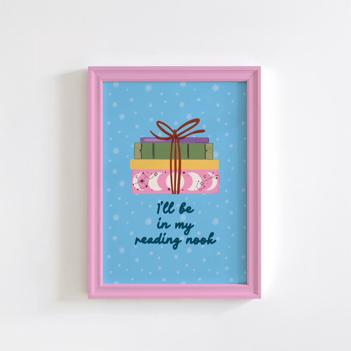 A cute pink print, featuring an illustration of a pack of books, and the quote 'I'll be in my reading nook' underneath.