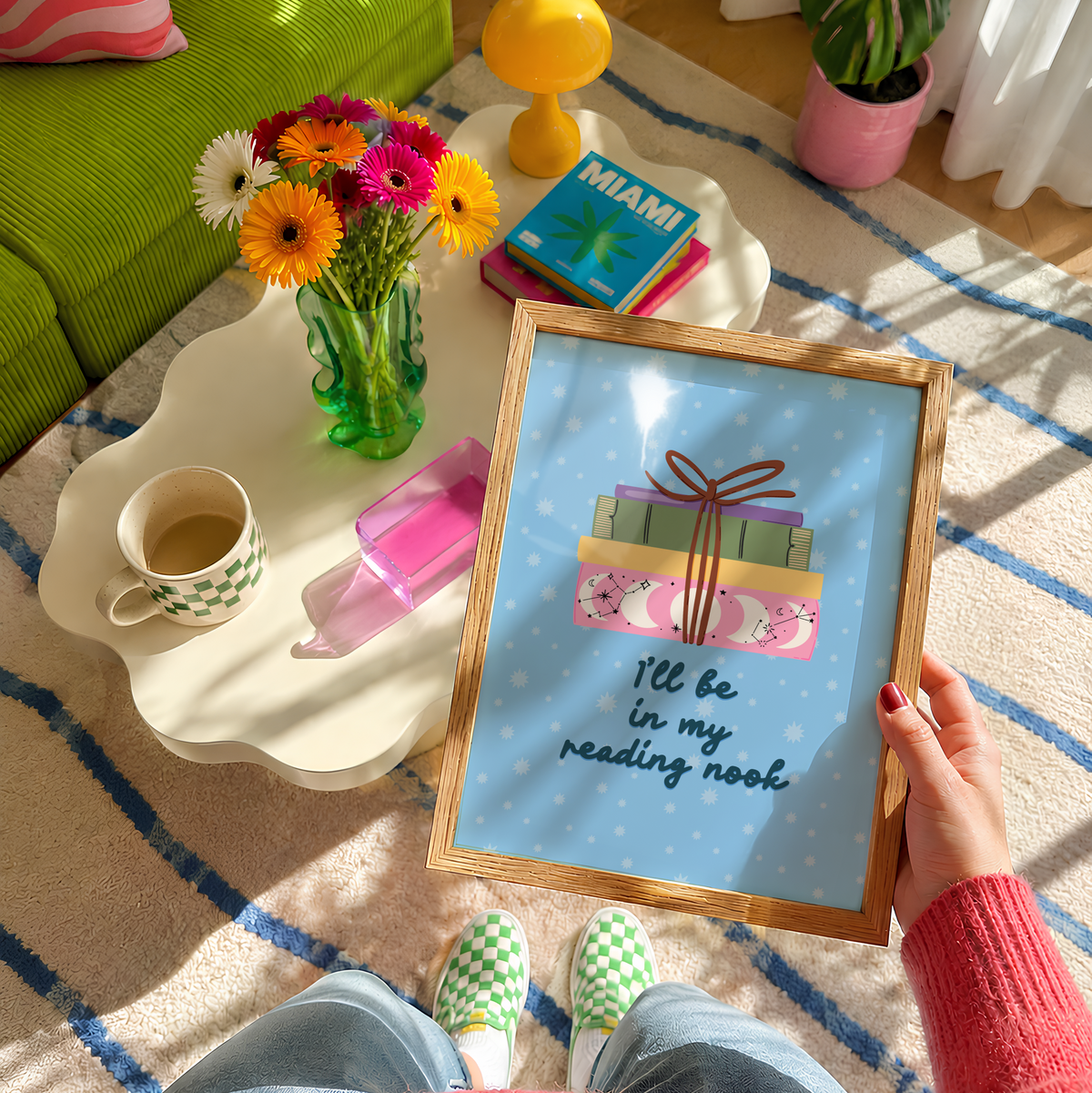 A cute pink print, featuring an illustration of a pack of books, and the quote 'I'll be in my reading nook' underneath.
