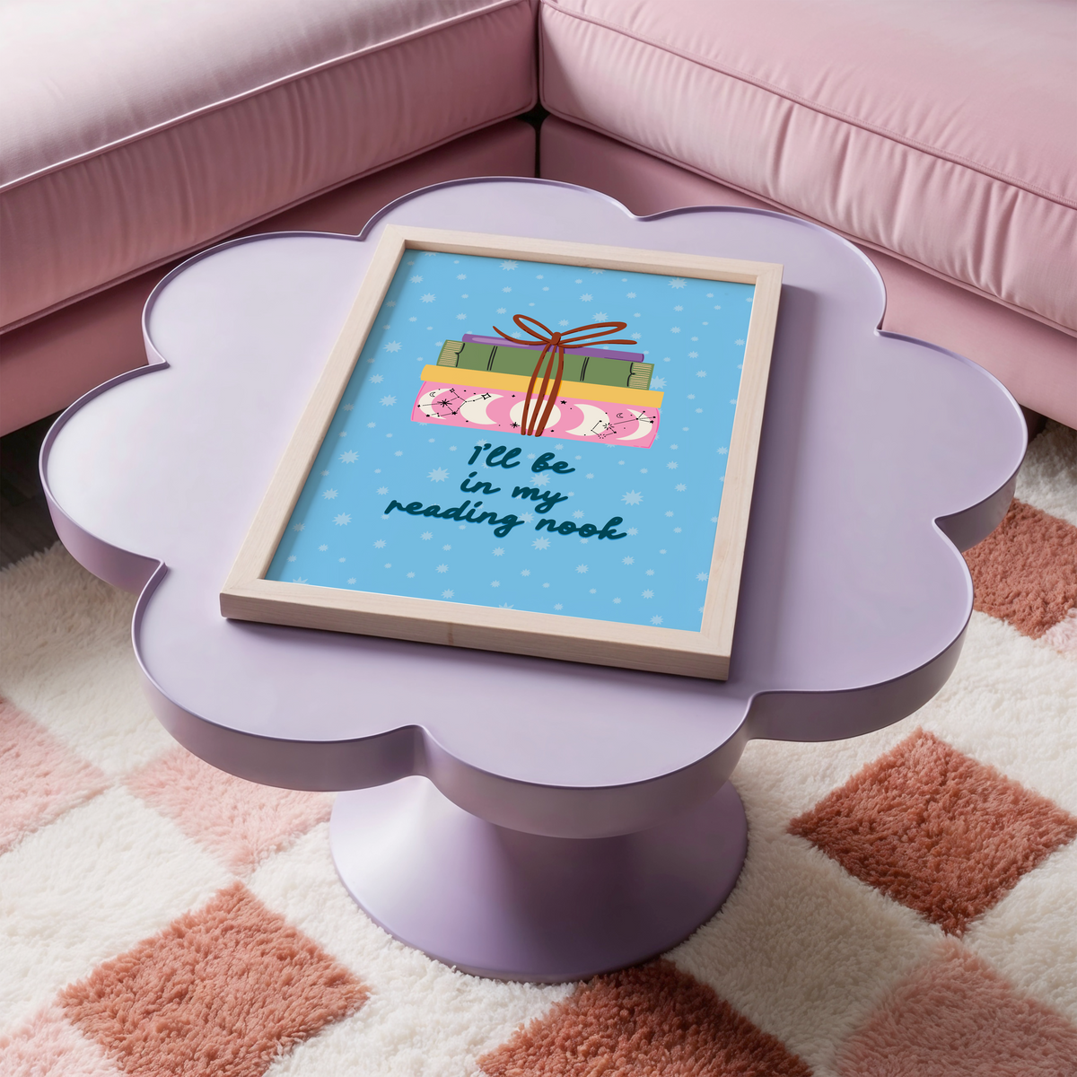 A cute pink print, featuring an illustration of a pack of books, and the quote 'I'll be in my reading nook' underneath.