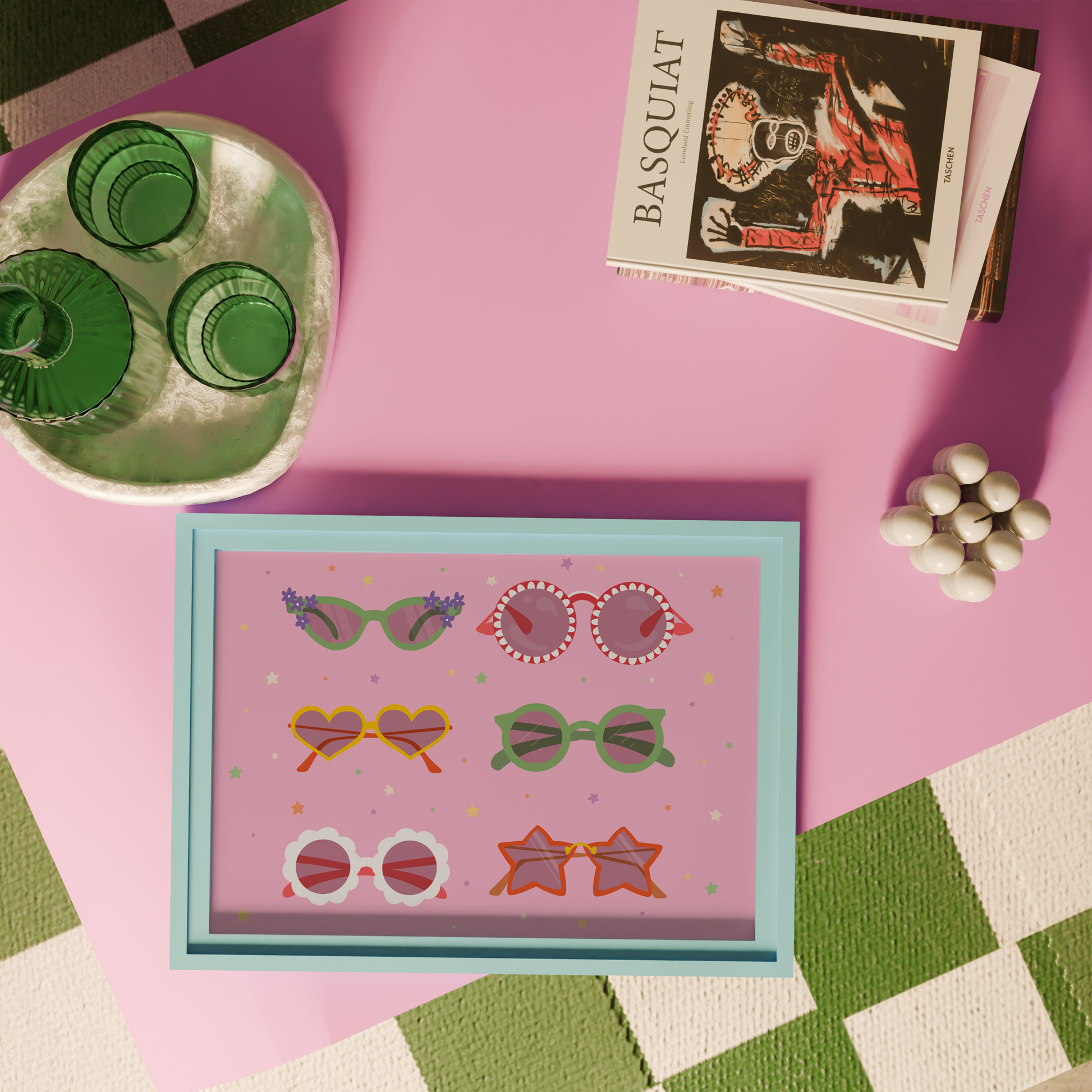 A pink print, with 6 pairs of different colourful sunglasses illustrated, in all different shapes. The background of the print is decorated with little colourful star illustrations.