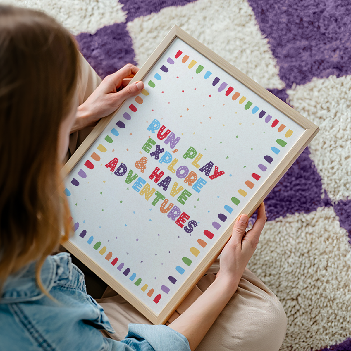 An art print with colourful text reading 'RUN, PLAY, EXPLORE & HAVE ADVENTURES'.