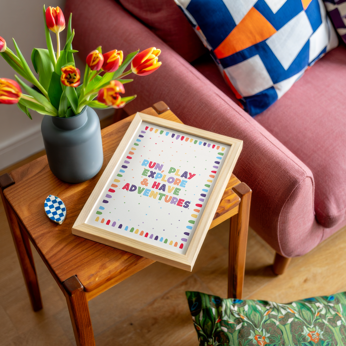 An art print with colourful text reading 'RUN, PLAY, EXPLORE & HAVE ADVENTURES'.