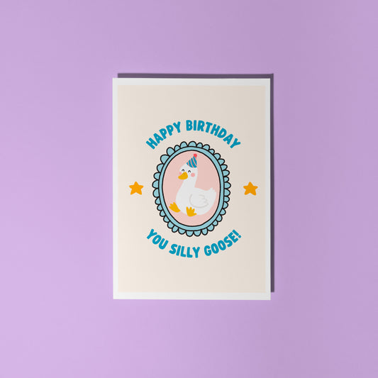A birthday card with an illustration of a goose in a party hat, with text around it saying 'happy birthday you silly goose'.