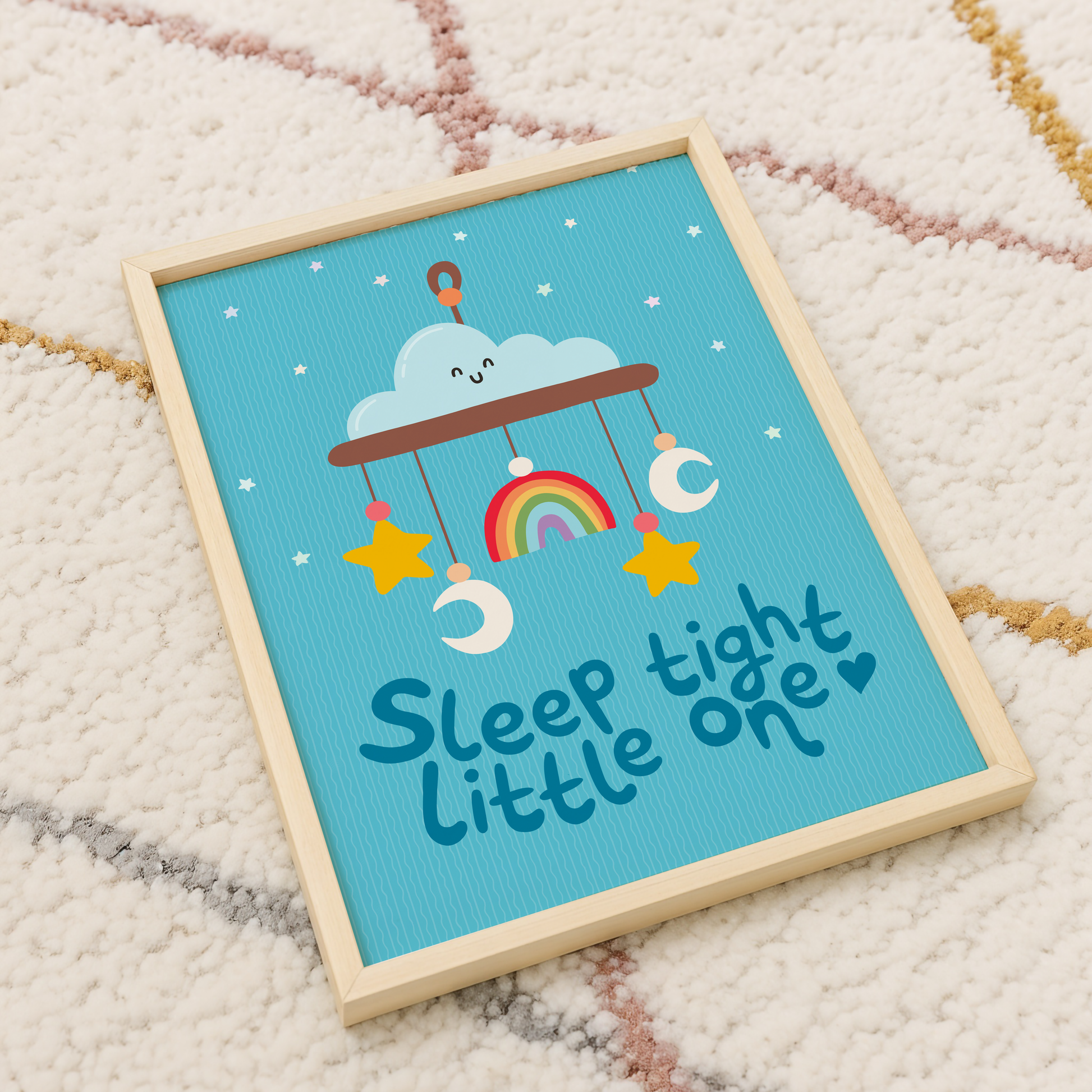 A blue print with an illustration of a children's mobile, and the words 'sleep tight little one' underneath.