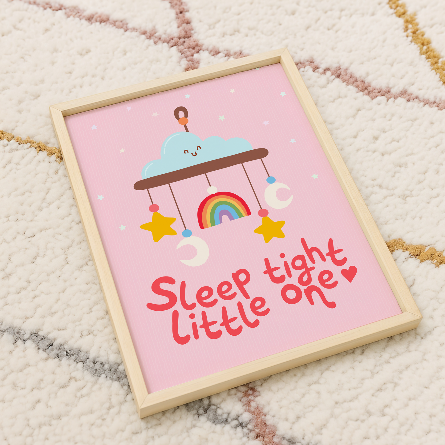 A pink print with an illustration of a children's mobile, and the words 'sleep tight little one' underneath.