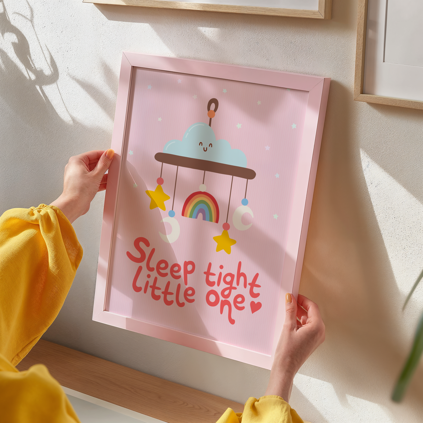 A pink print with an illustration of a children's mobile, and the words 'sleep tight little one' underneath.