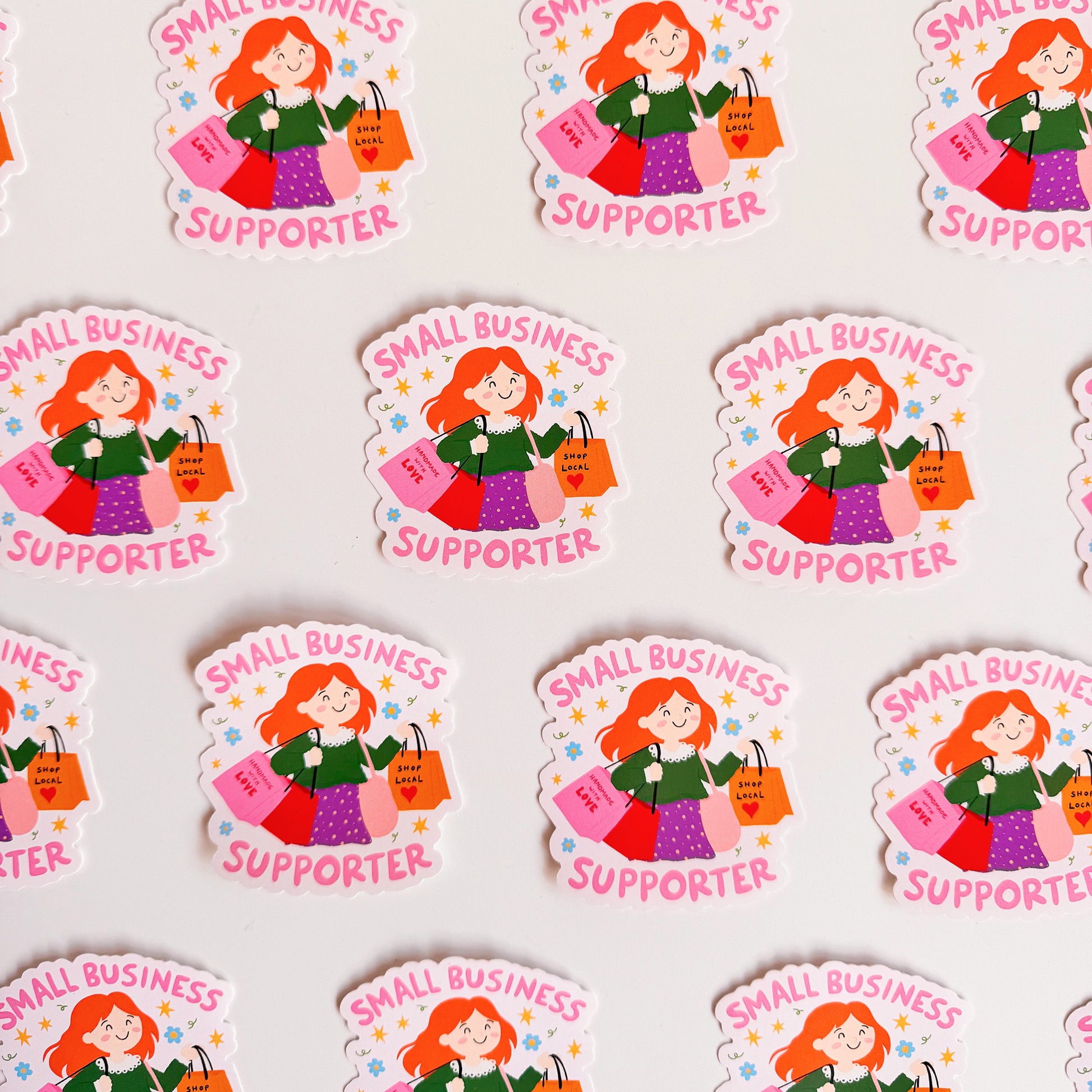 A vinyl sticker with n illustration of a girl holding shopping bags and text that reads 'Small Business Supporter'.