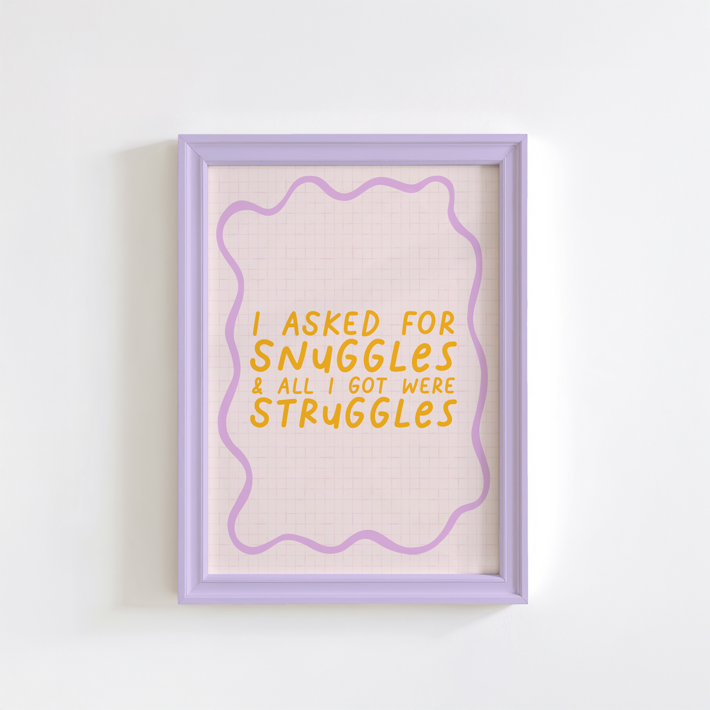 A cute quote print, saying I asked for snuggles, and all I got were struggles on a pale pink background with a purple squiggly border.