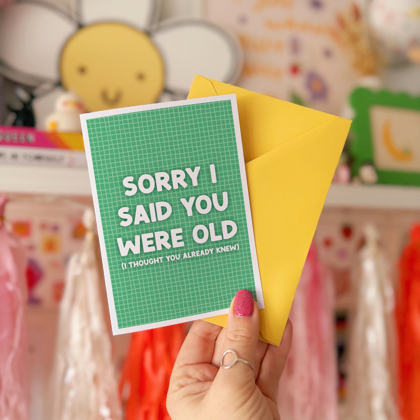 A green birthday card, with a humorous saying on the front - "Sorry I Said You Were Old (I thought you already knew)"