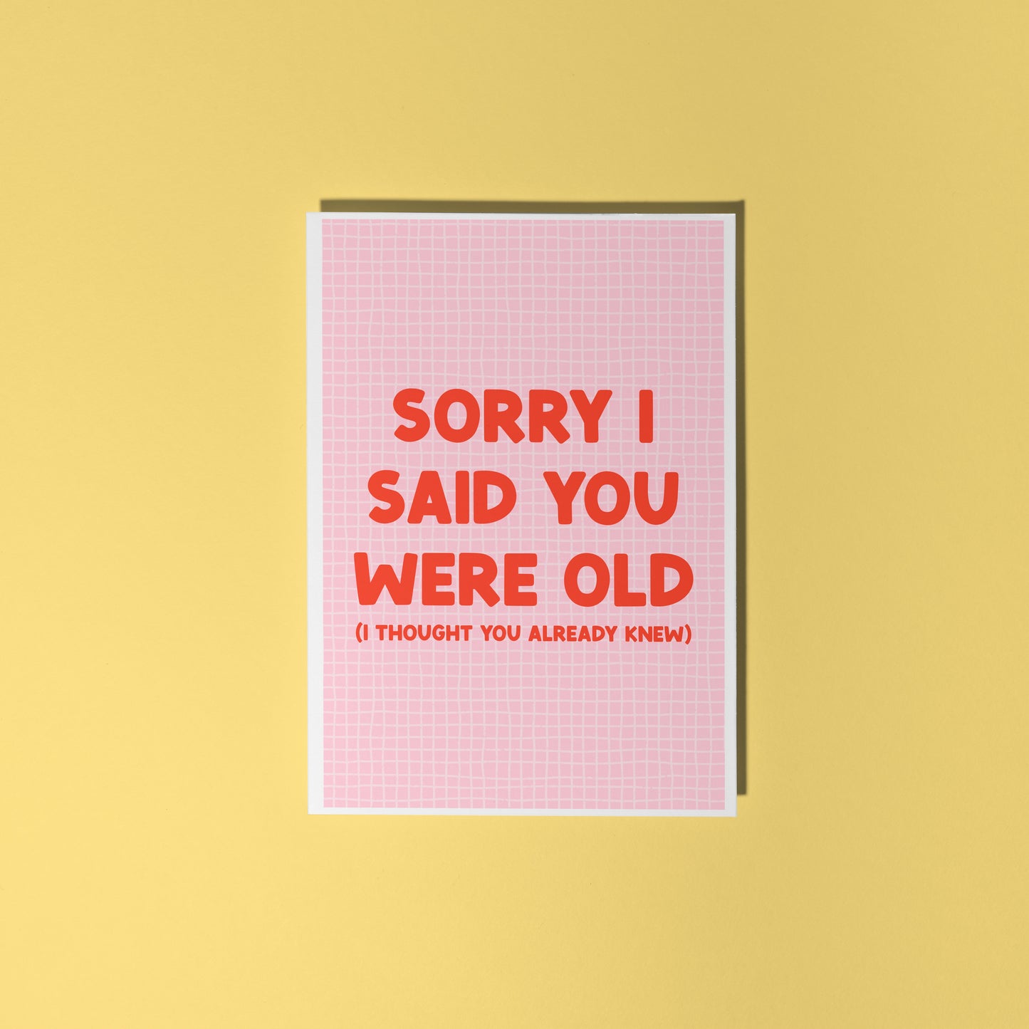A pink and red birthday card, with a humorous saying on the front - "Sorry I Said You Were Old (I thought you already knew)"
