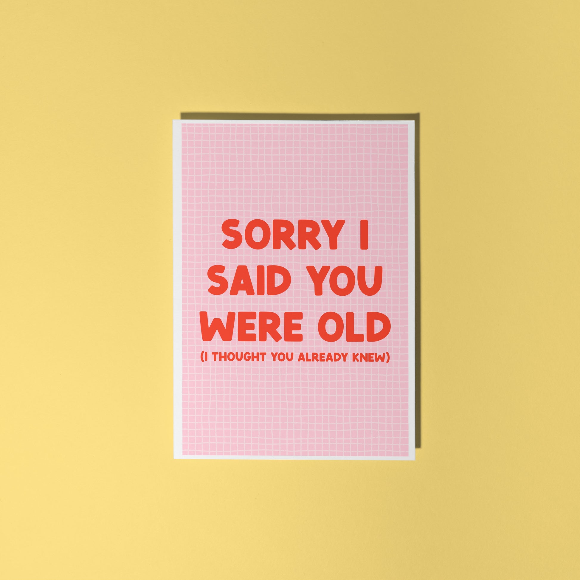 A pink and red birthday card, with a humorous saying on the front - "Sorry I Said You Were Old (I thought you already knew)"