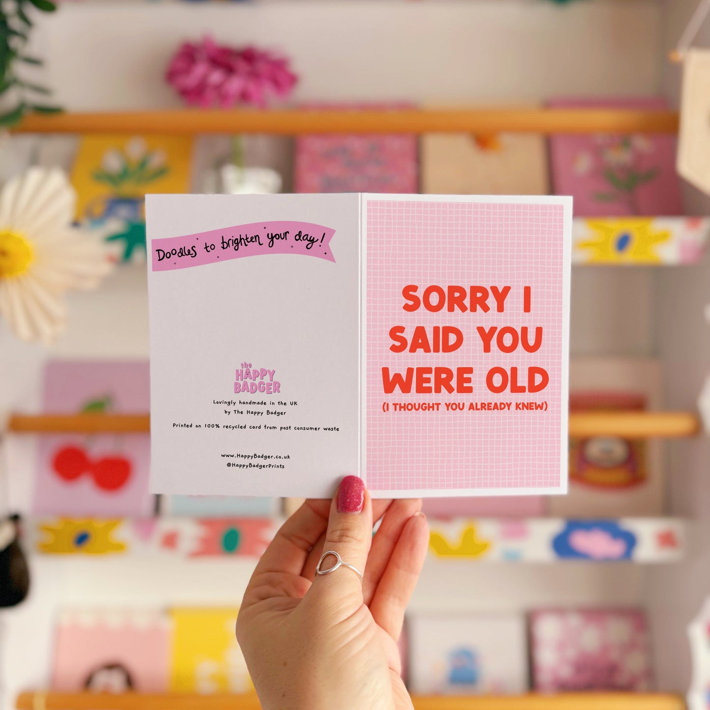 A pink and red birthday card, with a humorous saying on the front - "Sorry I Said You Were Old (I thought you already knew)"