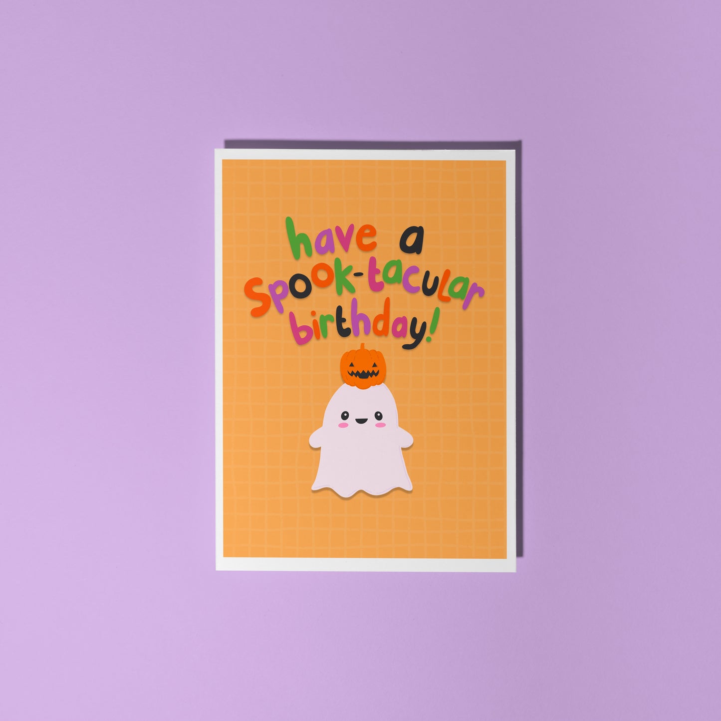 A halloween themed birthday card, with a cute ghost illustration and writing that says 'have a spook-macular birthday!'.