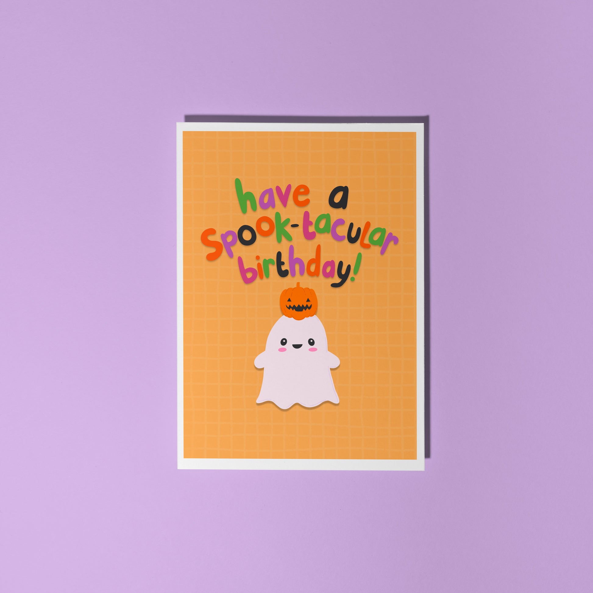 A halloween themed birthday card, with a cute ghost illustration and writing that says 'have a spook-macular birthday!'.