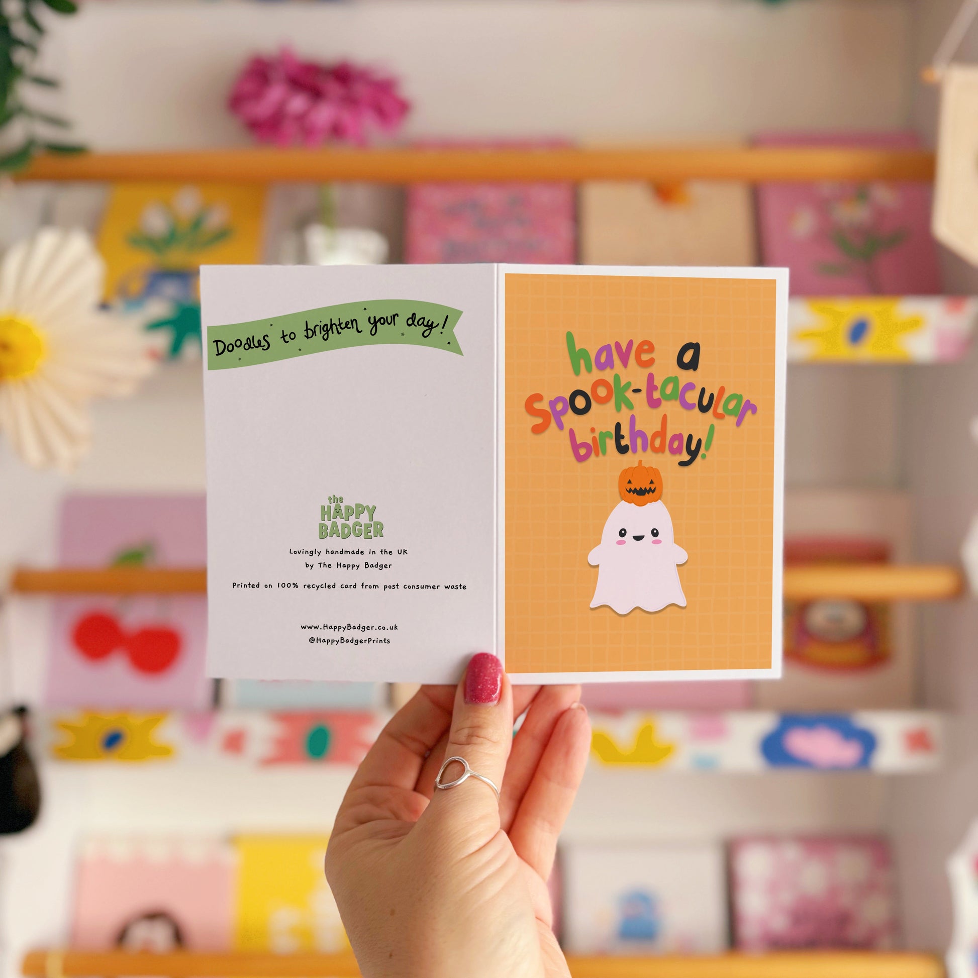 A halloween themed birthday card, with a cute ghost illustration and writing that says 'have a spook-macular birthday!'.