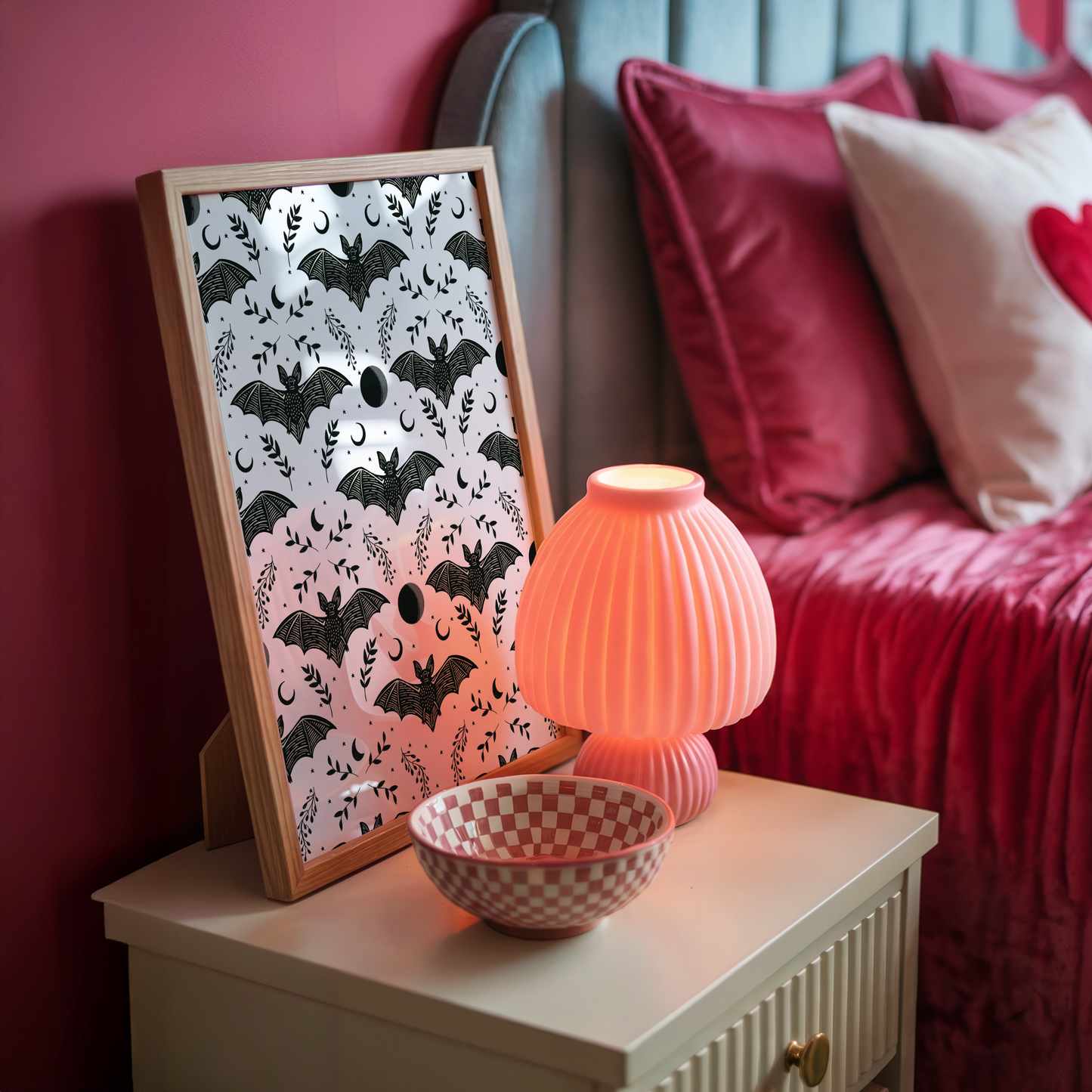 A halloween themed print with a repeating pattern of spooky bats, leaves and moons.