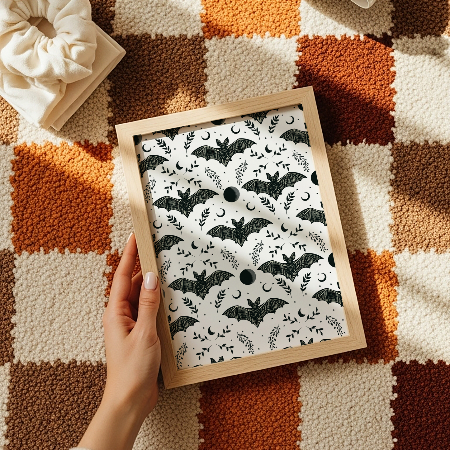 A halloween themed print with a repeating pattern of spooky bats, leaves and moons.