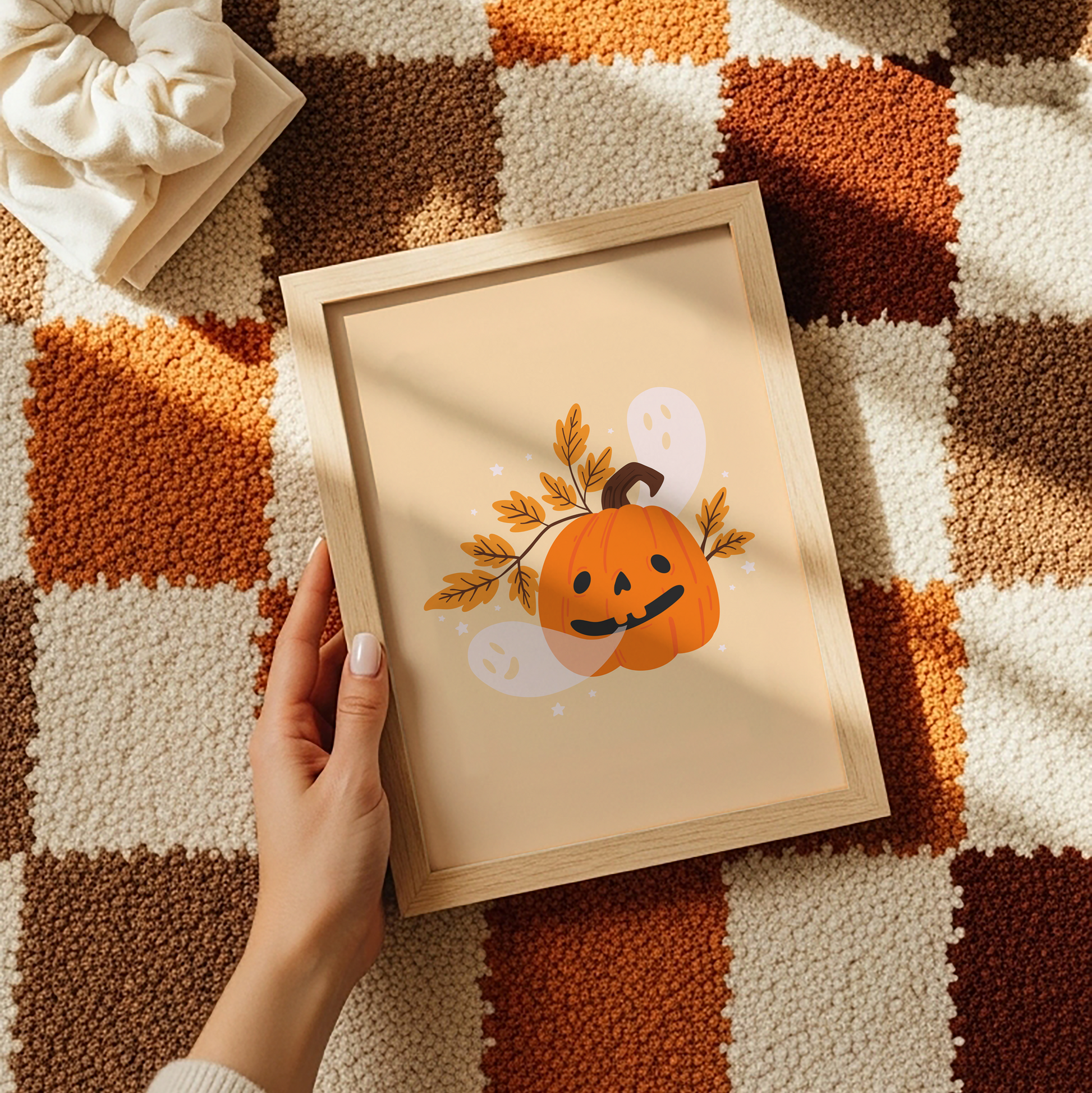 A warm toned print with an illustration of a dorky looking Halloween pumpkin. Come out of the pumpkin's mouth are ghosts.
