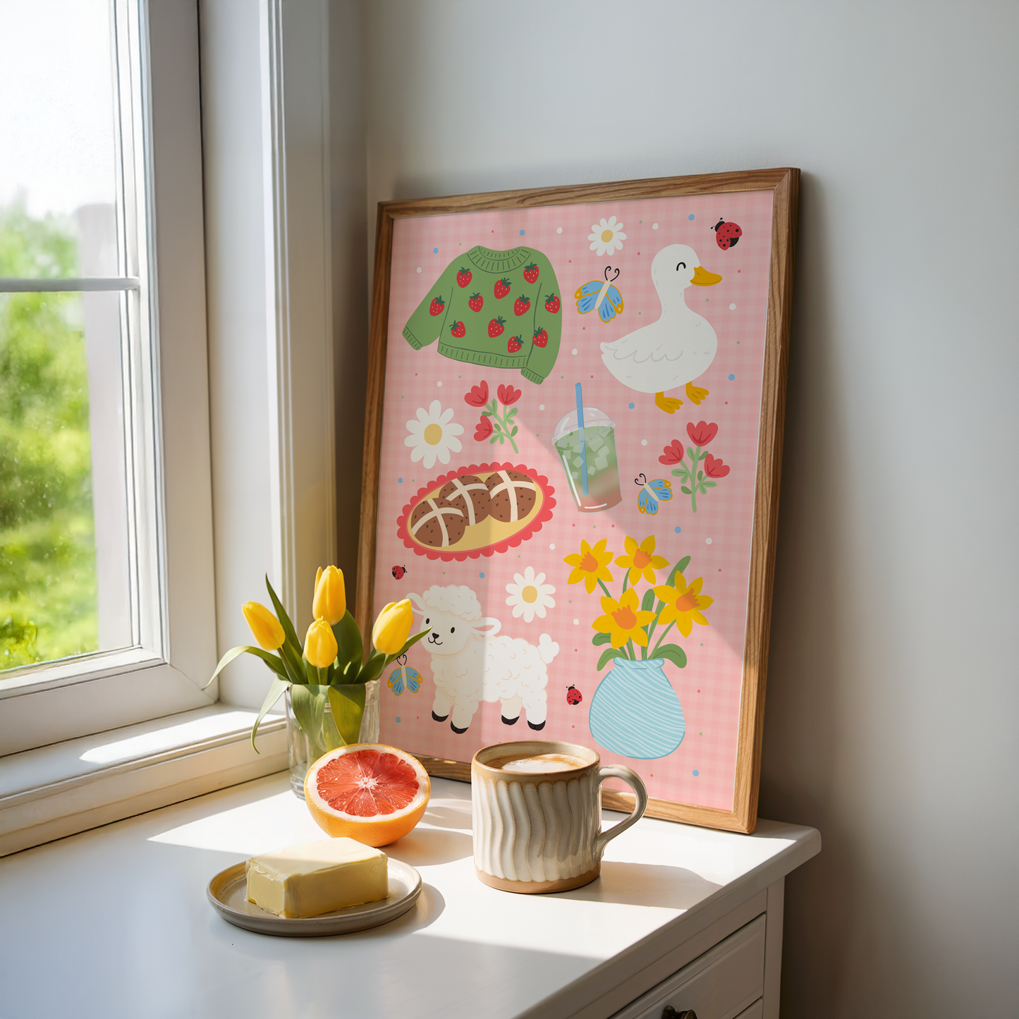 A pink gingham print, with spring themed illustrations - hot cross bunds, iced matcha latte, a duck, a lamb, daffodils and a strawberry print jumper.