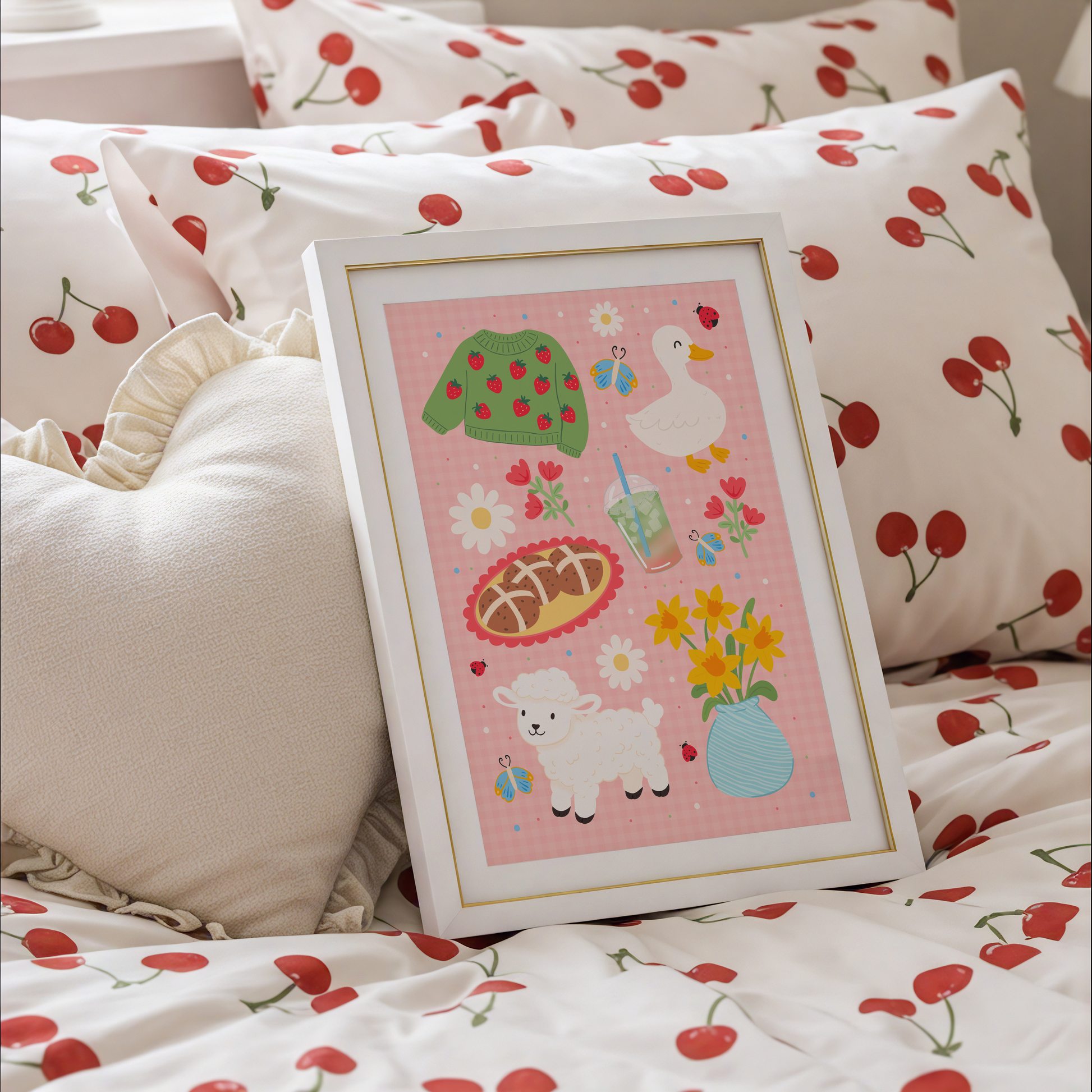 A pink gingham print, with spring themed illustrations - hot cross bunds, iced matcha latte, a duck, a lamb, daffodils and a strawberry print jumper.
