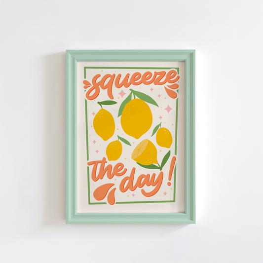 An art print with the text 'squeeze the day!' surrounded by illustrations of lemons and leaves in shades of yellow, green, and orange.