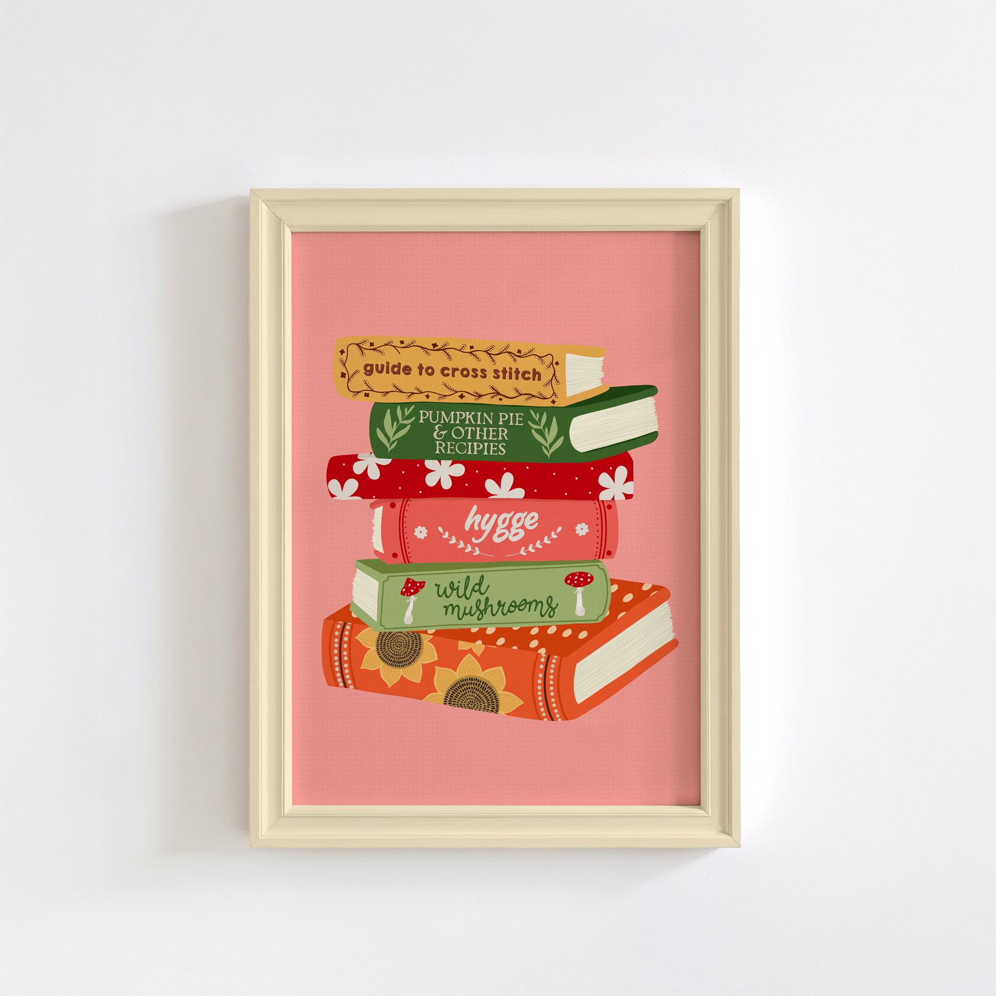 A print featuring six books stacked on top of each other, in autumnal shades and themes on a peachy pink background.