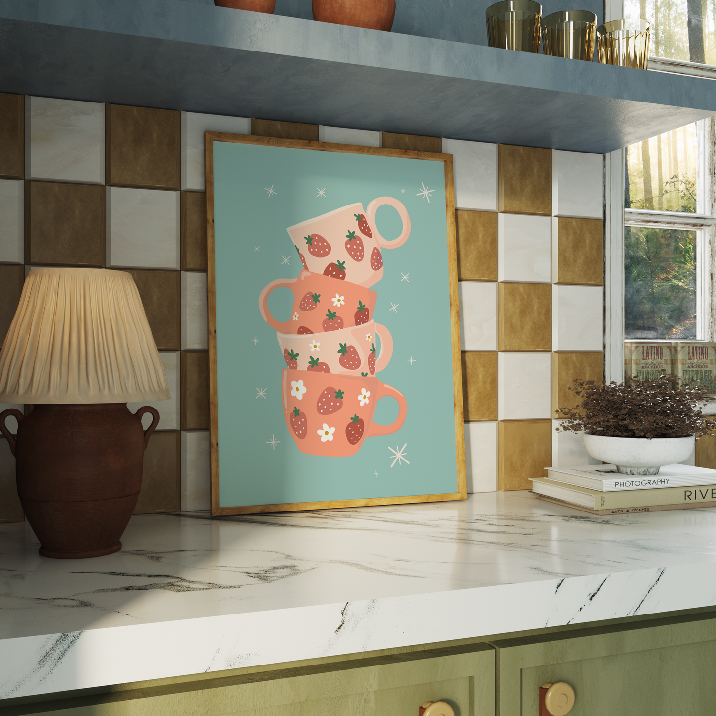 A teal blue print with an illustration of four stacked mugs in shades of orange, with strawberry illustrations on them.