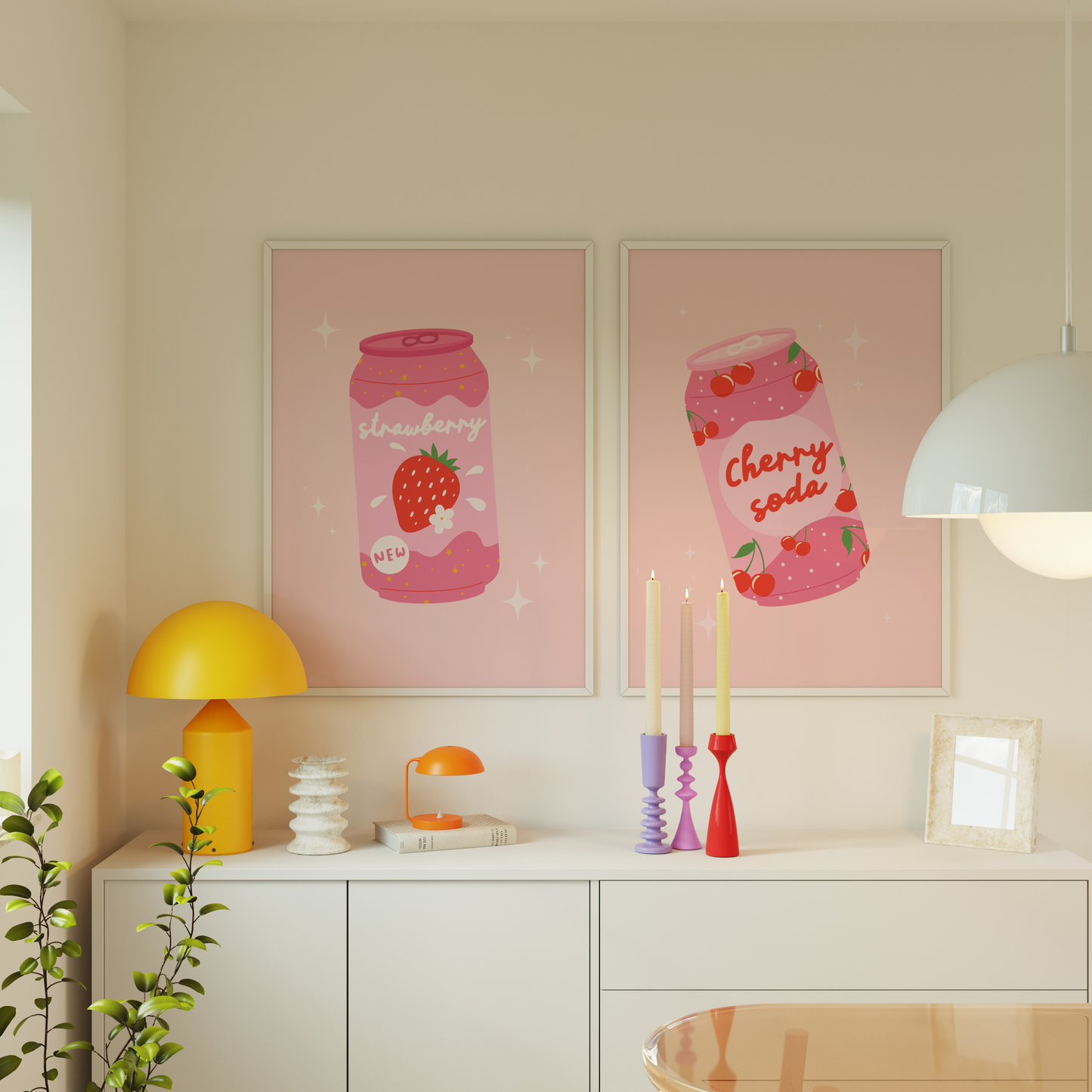 Two pink prints showing an illustration of a can of cherry soda, and a can of strawberry soda, both in a quirky kawaii style.