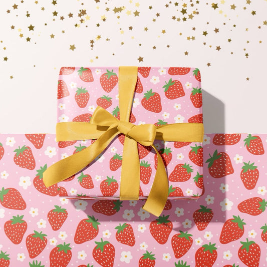 A gift wrapped present, wrapped up in strawberry print gift wrap from The Happy Badger.