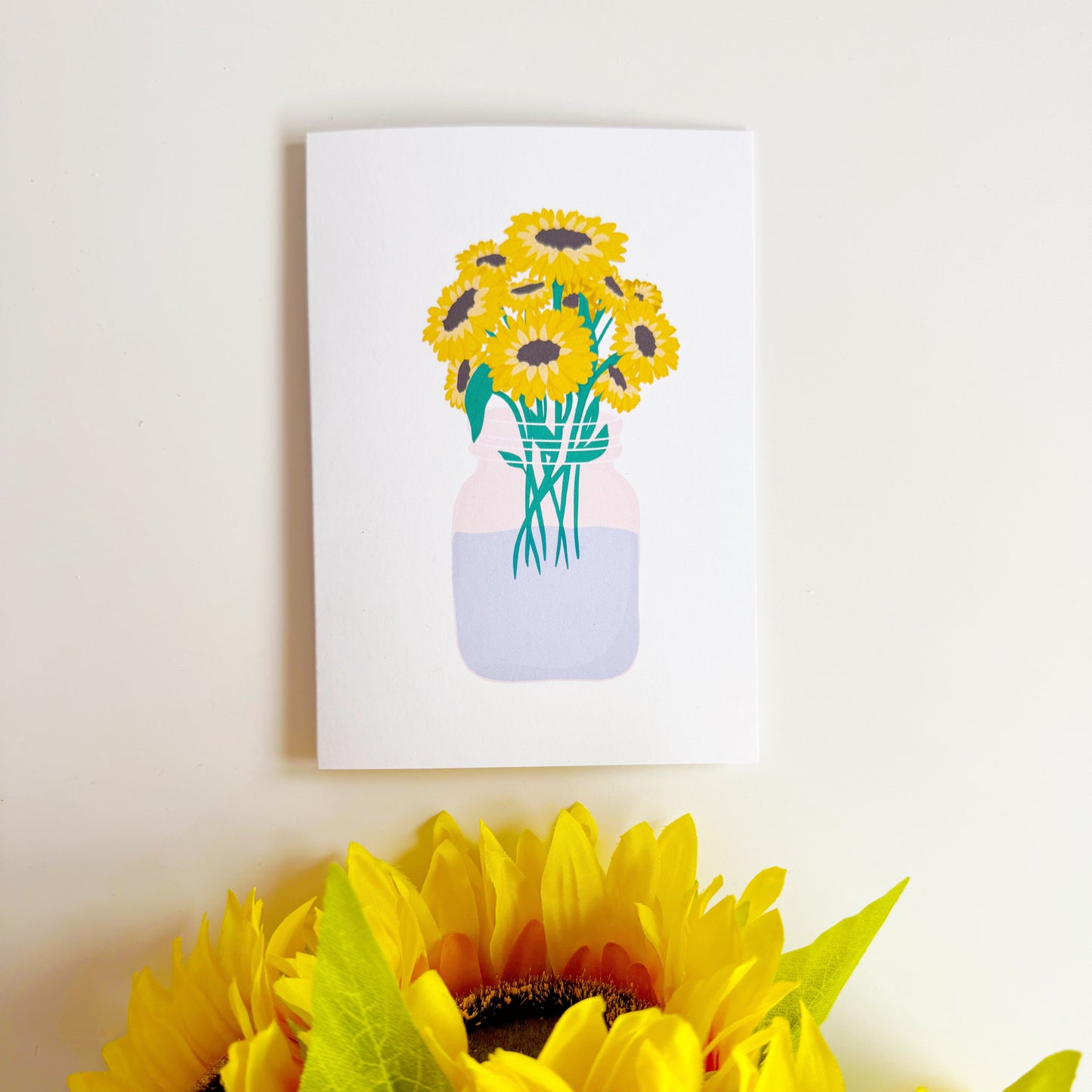 A greetings card with a bouquet of flowers, the card is otherwise blank to convey any sentiment.